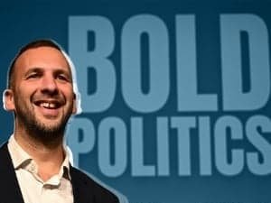 Photo of a smiling Zack Polanski with the words Bold Politics behind him