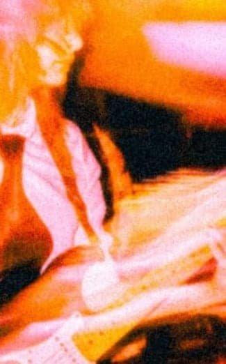 Blurred photo of a musician with long hair and an electric guitar